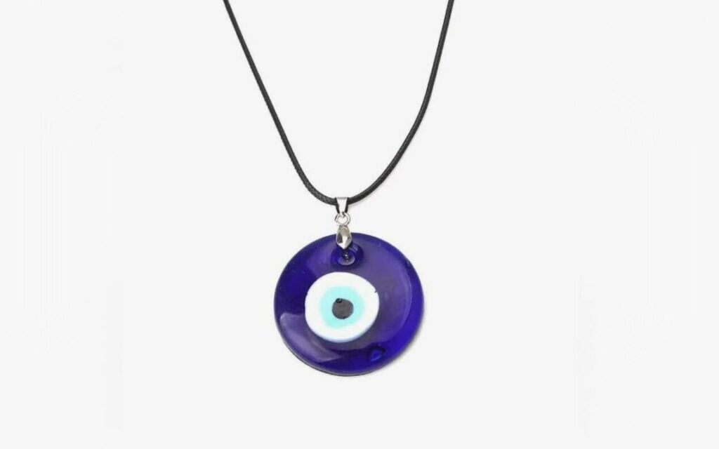 Blue evil eye pendant necklace on a black cord.