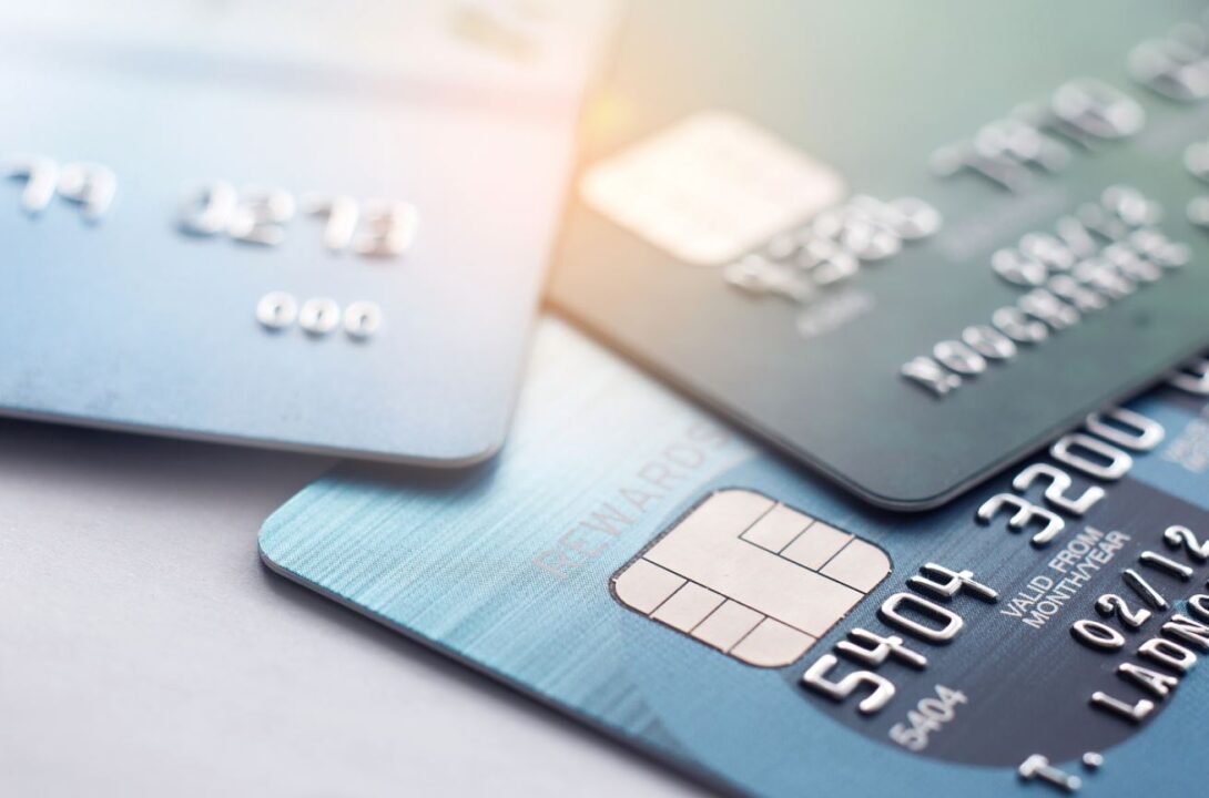 Close-up of overlapping credit cards with visible chip and numbers.