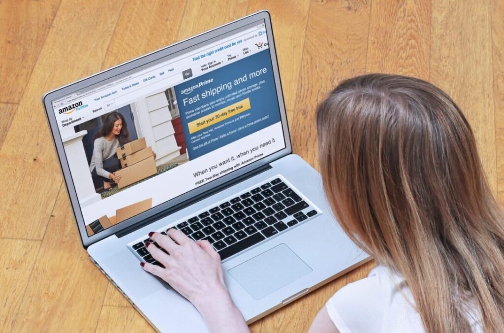 A person browsing the Amazon website on a laptop, showing a promotion for fast shipping with Amazon Prime.