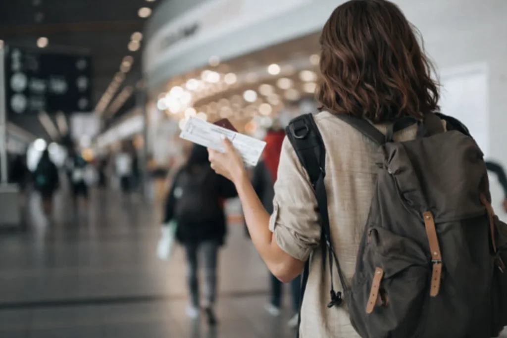 A woman is walking in an airport catching the next flight in an international airport