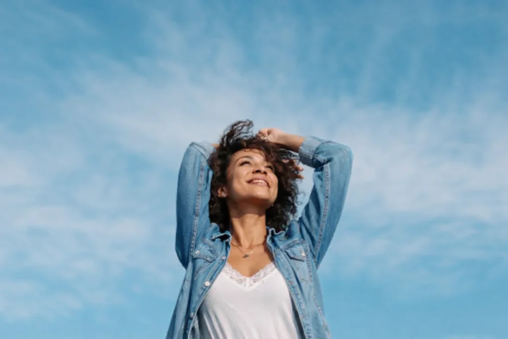 Living the life - a lifestyle concept.A woman in blue jeans shirt is enjoying the sun and the life